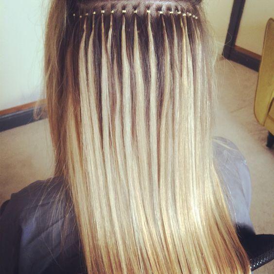 Micro bead hair extensions being applied strand by strand